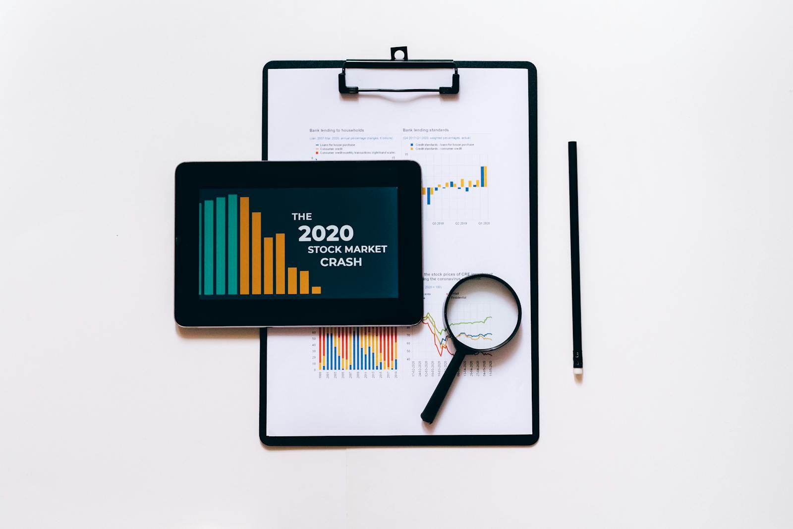 Clipboard with Statistical Data and Digital Tablet with Stock Market Display on Screen